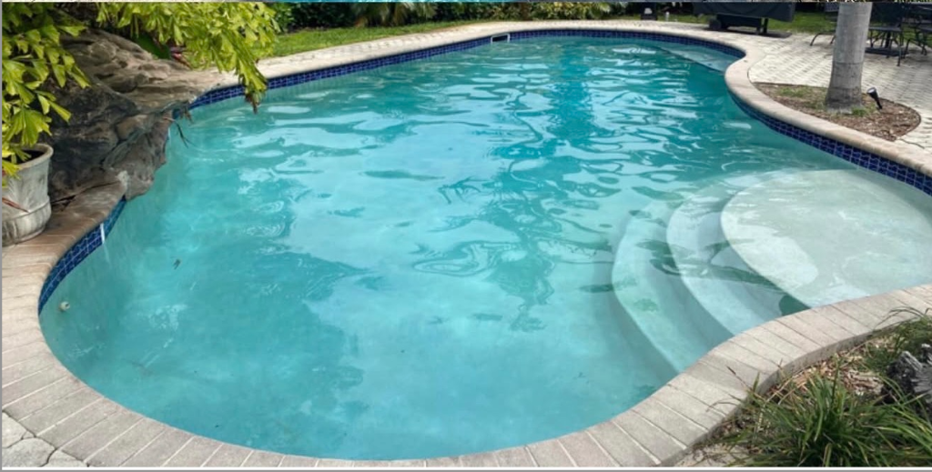 Pool with dull water color and surface staining before acid wash