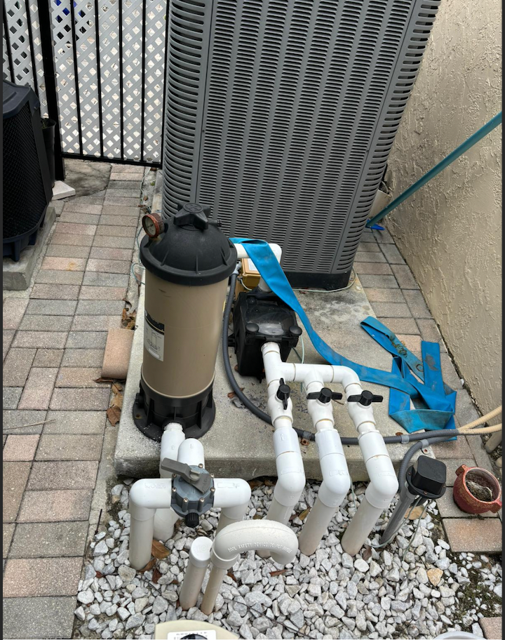 Old pool filter system with worn plumbing before replacement