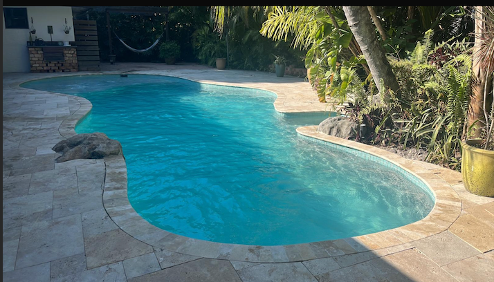 Crystal clear blue pool with beautiful tropical setting after recovery