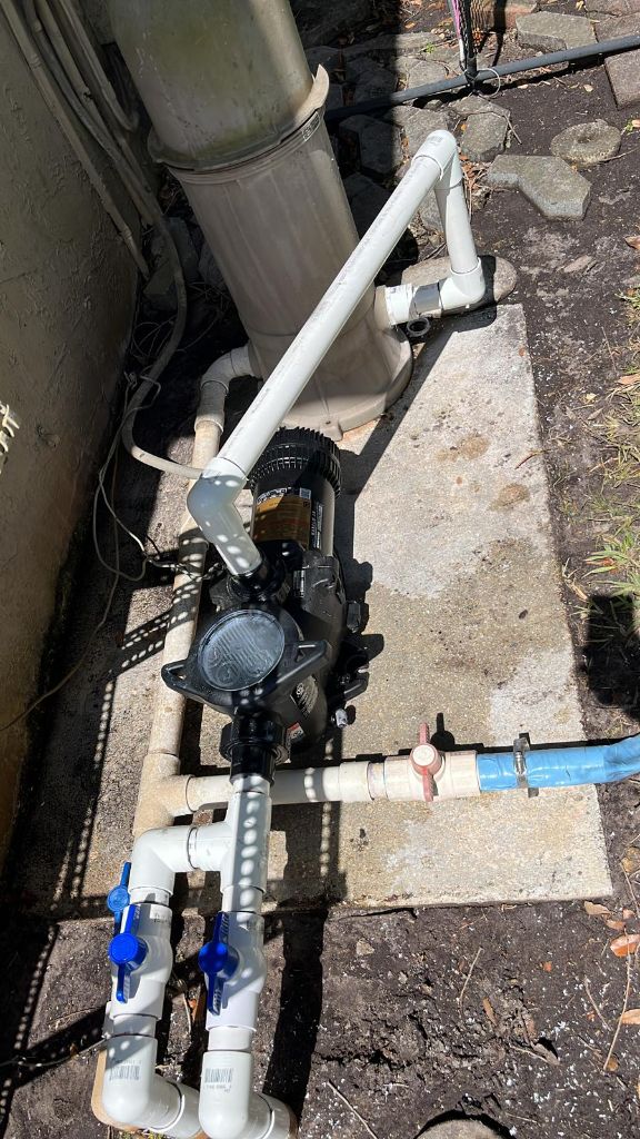 New modern pool pump with clean white PVC plumbing