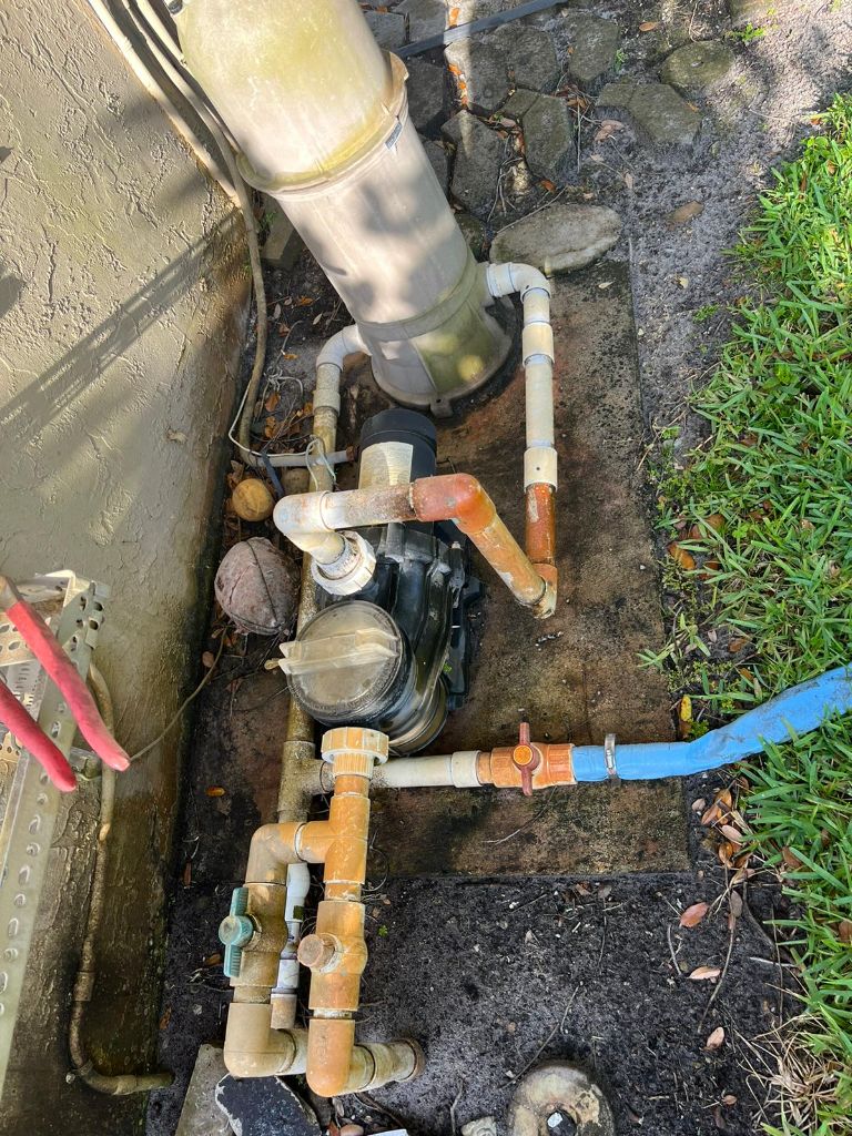 Old worn pool pump with corroded plumbing and valves